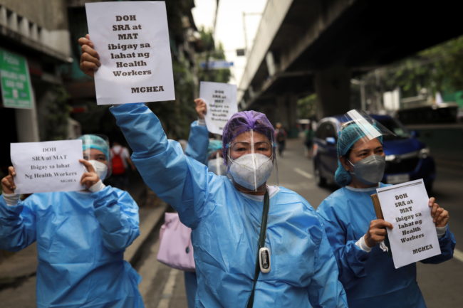 Healthcare workers protest outside the Department of Health in Manilla