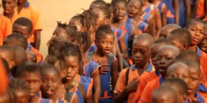Group of African children wearing school uniforms standing in lines